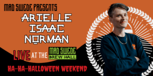 Arielle Isaac Norman posing against a black and orange Halloween backdrop.