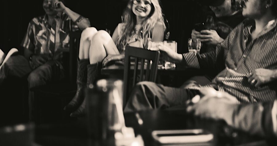 Black and white photo of people laughing.